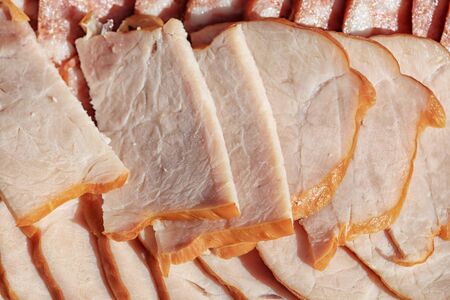 macro meat and sausage sliced on a picnic in the summer garden in natural lightの写真素材