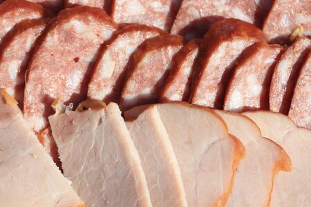 macro meat and sausage sliced on a picnic in the summer garden in natural lightの写真素材