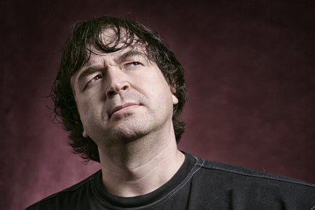 Portrait of a charismatic adult man on dark background Studio