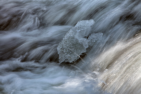 isolated background current flow texture in a river in early springの写真素材