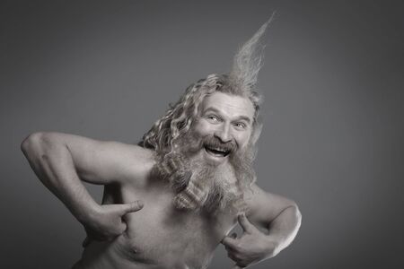 closeup portrait of the eccentric with a tuft on his head on a gray background studioの写真素材