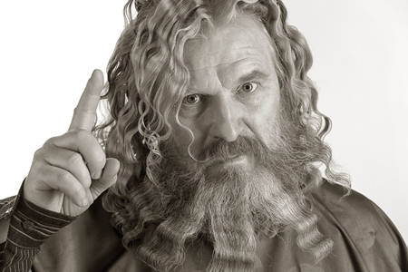 closeup portrait of an adult red-haired man with long wavy hair and beard on a white backgroundの写真素材