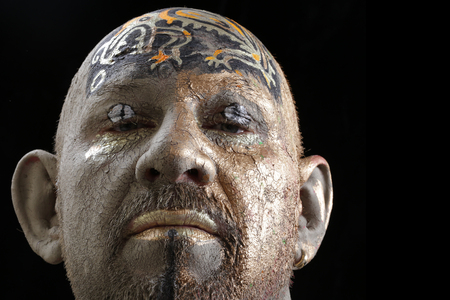 close-up portrait of a man in the clay body art , studio on a dark backgroundの写真素材