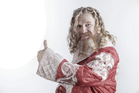 closeup portrait funny santa claus, red-haired man with long wavy hair and beard on white background studioの写真素材