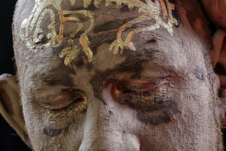 close-up portrait of a man in the clay body art , studio on a dark backgroundの写真素材