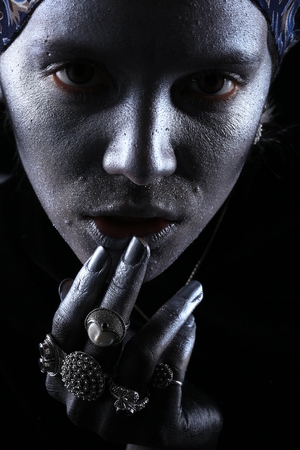 Macro silver jewelry in female hands model body art on black backgroundの写真素材