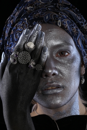 Macro silver jewelry in female hands model body art on black backgroundの写真素材
