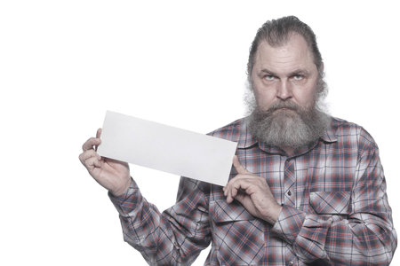 Closeup portrait of an adult male with a beard with blank sign in hands on a white background studioの写真素材