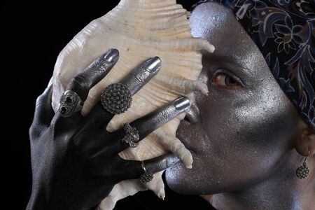 Macro silver jewelry in female hands model body art on black backgroundの写真素材
