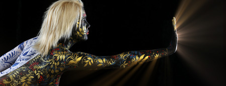 Body art portrait of a girl in the style of Khokhloma and Gzhel on a black background studioの写真素材