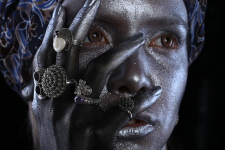 Macro silver jewelry in female hands model body art on black backgroundの写真素材
