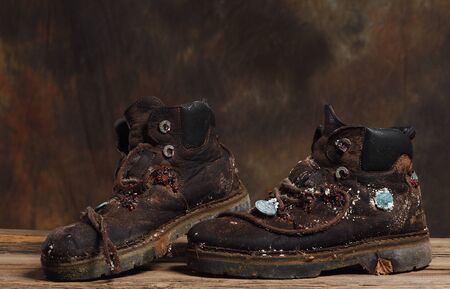 very old hiking boots with a new civilization