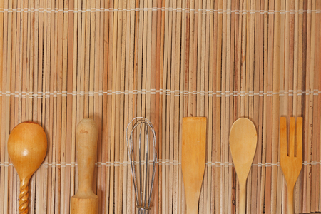 kitchen utensils lie on the surface of a wooden tableの写真素材