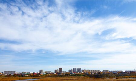 Full frame of blue sky with clouds and city view of the metropolisの写真素材