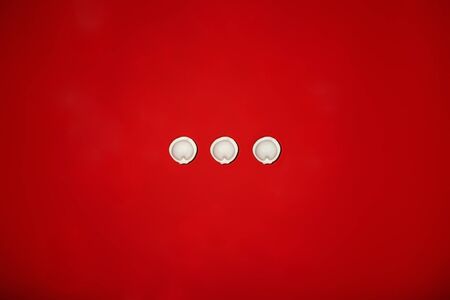 Three snow-white dumplings on a red background