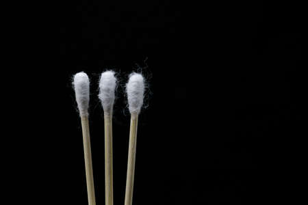 Cotton buds on isolated black background
