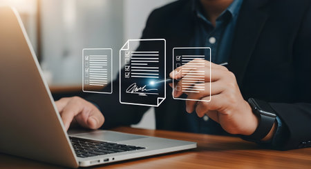 Businessman working with laptop computer with document icon diagram on screen.の素材
