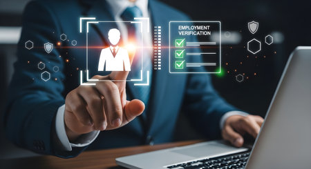 A professional in a suit interacts with a holographic employment verification interface projected above a laptop. The image conveys secure, high-tech HR screening and digital onboarding, suitable for marketing automated background checks and talent management solutions.の素材