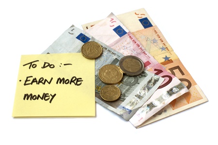 To Do List Earn More Money post it note stuck to pile of savings money both bank notes and loose change in Euro currencyの写真素材