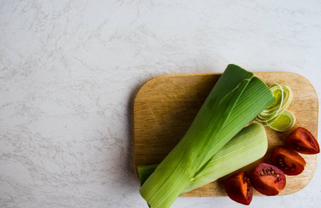 leek, cherry tomatoes on wooden boardの写真素材