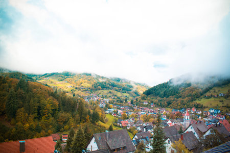 clouds and fog over the village in the mountains. autumn. Germanyの写真素材
