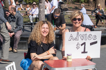 NEW YORK, USA - APRIL 14, 2018: Advice for 1 US dollar. Women in the park giving payed advices in the Park, New York City, USAのeditorial素材