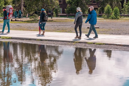 YELLOWSTONE NATIONAL PARK, WYOMING, USA - JUNE 18, 2018: Tourists at Yellowstone National Park. The boardwalk among pools and geysers. The barren snow-colored basin. Porcelain Basin of Norris Geyser Basin, Yellowstone National Parkのeditorial素材