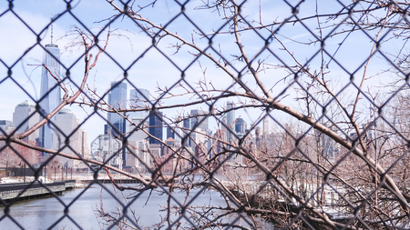 View of New York City cityscape, Lower Manhattan from the Jersey City through grid in winter dayの写真素材
