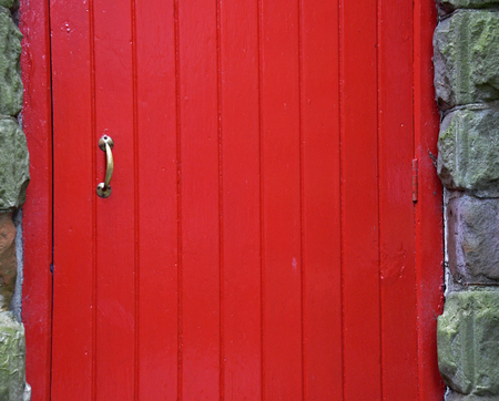 Brass handle on red doorの写真素材