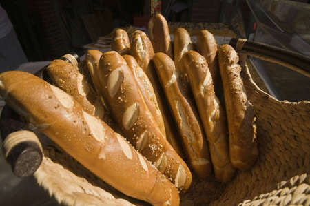 bunch of salted baguettes in a basketの写真素材