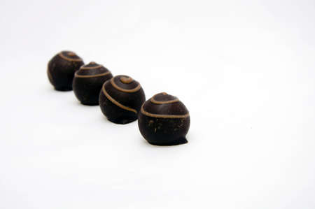 four chocolate candies blured and isolated on white backgroundの写真素材