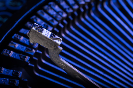 typewriter iron key isolated in blue backgroundの写真素材
