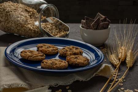 Cookies in blue plate with some ingredientsの写真素材