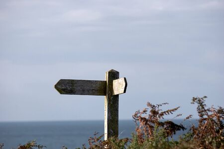 Weathered signpost on the Pembrokeshire Coastal Path in Walesの写真素材