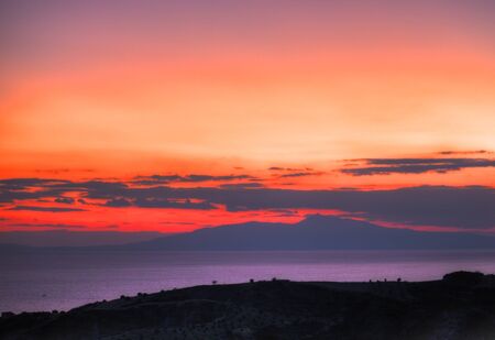 A sunset over the ocean  in Greeceの写真素材