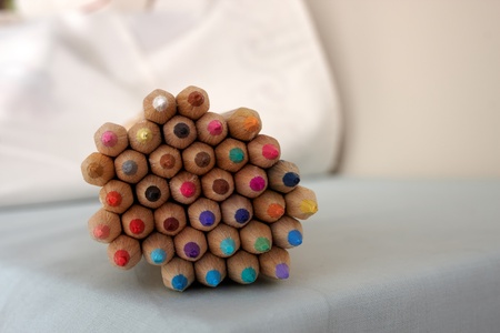Thirty six coloured pencils all stacked together