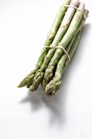 A bunch of asparagus held together with elastic bandsの写真素材