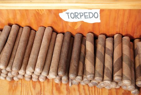 Cigars stacked on a shelf for sale