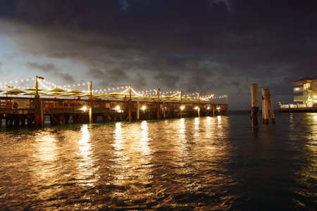 A restaurant on a pier lit up at eveningのeditorial素材