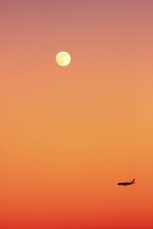 An airplane in the sky at sunsetのeditorial素材