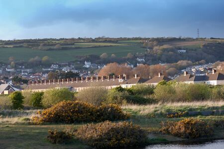 Homes at the bottom of a mountain in the Welsh countrysideの写真素材