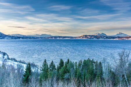 Lofoten islands, Norway. Colorful winter landscape in blue hours. . Snowy mountains in background.の写真素材