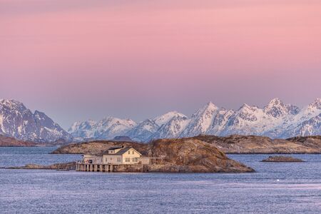 wooden houses with dramatic sunset in background in lofoten, Norway. Amazing landscape.の写真素材
