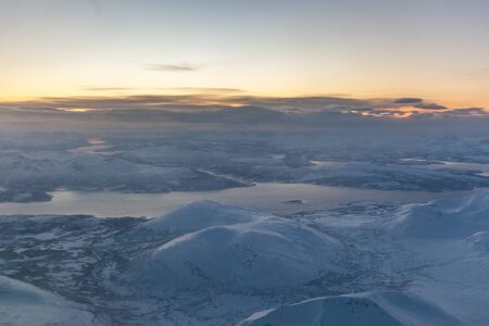 Looking through window aircraft during flight in wing with a nice sunsetの写真素材