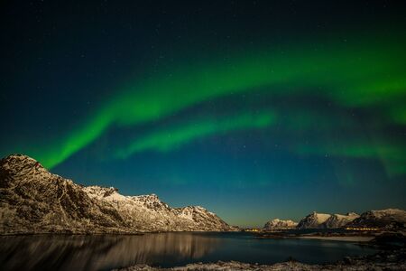 northern lights, Aurora borealis over fjord mountains with many stars on the sky in Lofoten islands, Norway, long shutter speed.の写真素材