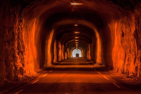 Dark tunnel in the mountain with lanterns. Typical tunnel in Norway on the Lofoten Islands.の写真素材