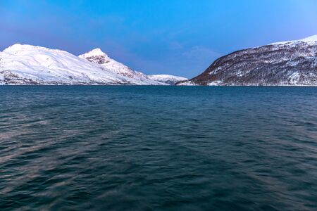 sunset with amazing magenta color over fjord Tromso, Norway. Winter. Polar night. long shutter speedの写真素材