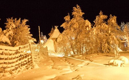 Typical swedish village. Winter landscape in the Arctic Circle in northern Sweden. Trees covered...