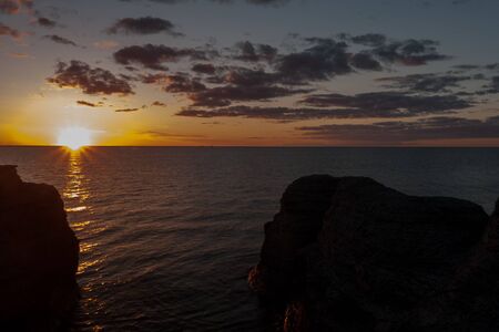 Sunset. Coastal limestone formations, raukar, at Byrum at the swedish island Oland, the island of...