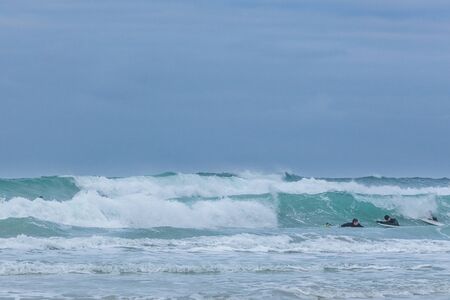 Surfing on picturesque arctic beach on Lofoten islands in Norway